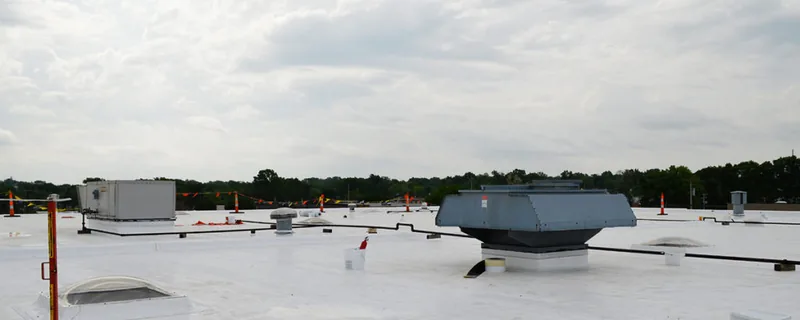 Flat commercial roof with rooftop HVAC unit and ventilation piping — John Beal Roofing commercial roofing in Eldon, MO