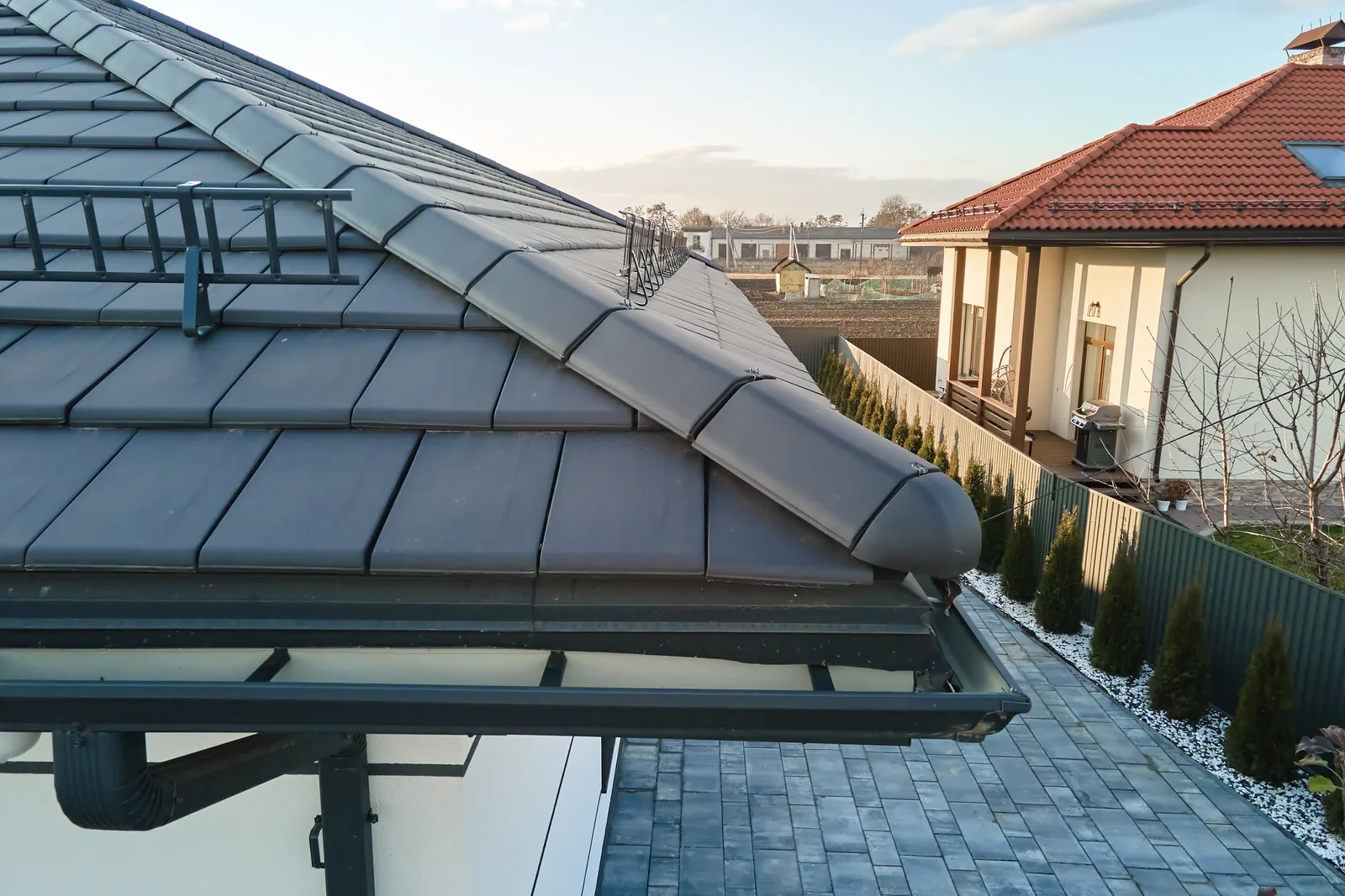 New metal gutter and downspout system installed on a residential eave — John Beal Roofing gutter installation in Clever, MO