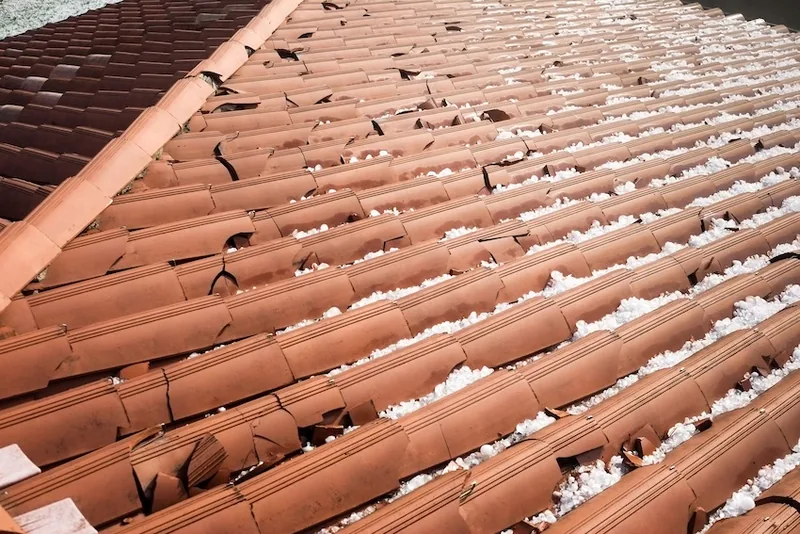 Hail damage showing pitted and dented metal roofing panels — John Beal Roofing roofing in Warsaw, MO