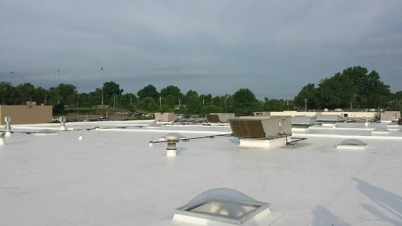 Commercial low-slope roof with rooftop HVAC units on a building John Beal Roofing worked on