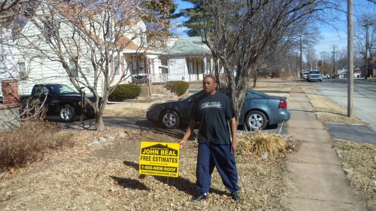 Homeowner with a John Beal free estimates yard sign in his front yard