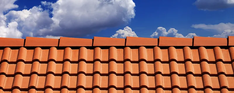 Curved clay roof tiles arranged in overlapping rows — John Beal Roofing roofing in Boonville, MO