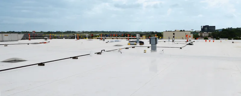 Large flat commercial roof membrane with rooftop HVAC units — John Beal Roofing commercial roofing in Fulton, MO