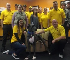 Roofing professionals in yellow shirts posing as a team — John Beal Roofing roofing in Plainfield, IN