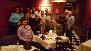 Company team gathered at a banquet dinner — John Beal Roofing commercial roofing in Springfield, MO