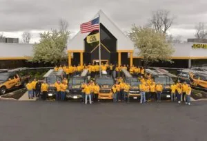 Company team gathered in front of the building for a group photo — John Beal Roofing storm damage restoration in Branson, MO