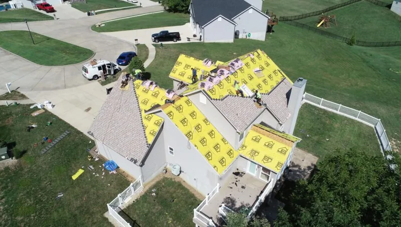 Aerial view of a commercial building roof undergoing maintenance — John Beal Roofing commercial roofing in Forsyth, MO