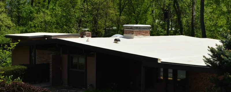Single-story home surrounded by mature trees and lawn — John Beal Roofing roofing in Osage Beach, MO