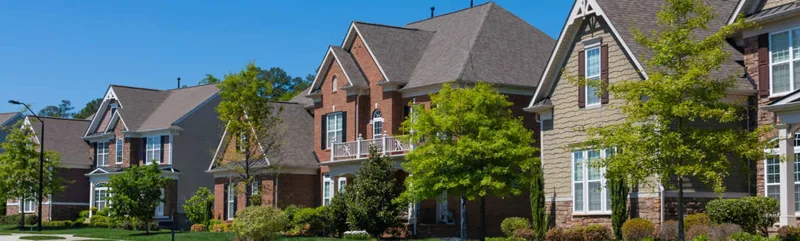 Residential neighborhood street of single-family homes — John Beal Roofing gutter installation in Stover, MO