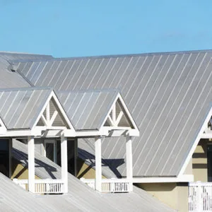 Sloped metal roof on a modern home with white trim — John Beal Roofing gutter installation in Fulton, MO