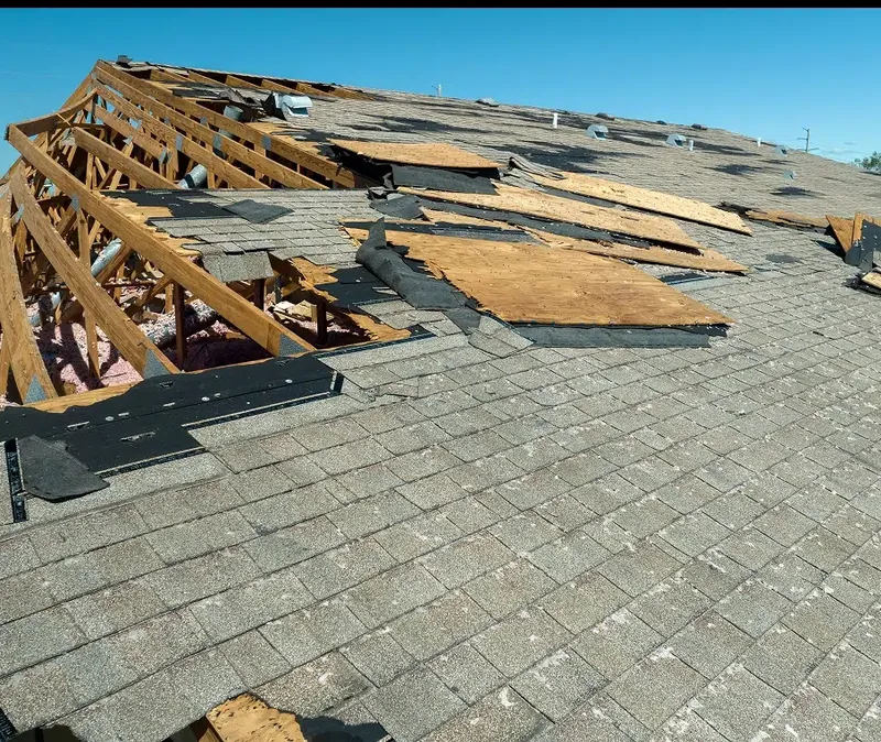 Storm damage showing broken roof rafters and plywood decking — John Beal Roofing roofing in Columbia, MO