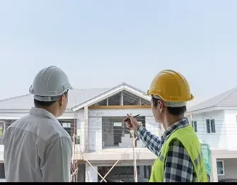 Contractors in hard hats examining plans at a job site — John Beal Roofing roofing in Brownsburg, IN
