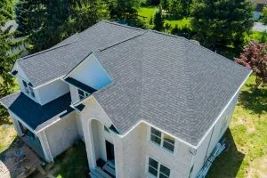 Two-story house with a dark shingle roof and light siding — John Beal Roofing roofing in Tuscumbia, MO