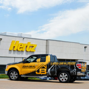 A John Beal truck that is parked in front of a commercial building we've done work on.